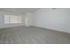 Open-concept living room featuring neutral carpet and a large window at 6623 N 85Th Ave, Glendale, AZ 85305