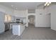 Open-concept living room features a kitchen, ceiling fan, and neutral carpet at 6623 N 85Th Ave, Glendale, AZ 85305