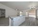 An open living area boasts an island and lots of natural light from sliding glass doors at 6623 N 85Th Ave, Glendale, AZ 85305