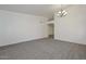 Living room featuring neutral carpet and an arched doorway at 6623 N 85Th Ave, Glendale, AZ 85305