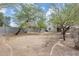 Spacious backyard with mature trees and privacy fence, offering a peaceful outdoor space at 6830 W Desert Ln, Laveen, AZ 85339