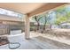 Covered patio with a view to the large, private backyard with gravel and trees at 6830 W Desert Ln, Laveen, AZ 85339