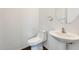 Cozy powder room features a pedestal sink and a toilet at 6830 W Desert Ln, Laveen, AZ 85339