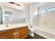 Bright bathroom featuring a bathtub, vanity, and a well-lit mirror at 6830 W Desert Ln, Laveen, AZ 85339