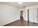Bedroom with hardwood floors and a closet featuring doors and an open entrance at 6830 W Desert Ln, Laveen, AZ 85339