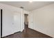 Bedroom with hardwood floors and a closet featuring doors and an open entrance at 6830 W Desert Ln, Laveen, AZ 85339