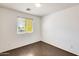Bedroom featuring hardwood floors, a window, and bright white walls at 6830 W Desert Ln, Laveen, AZ 85339