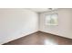 Bedroom featuring hardwood floors, a window, and bright white walls at 6830 W Desert Ln, Laveen, AZ 85339