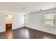 Large bedroom with hardwood floors, windows, and an entrance to the bathroom at 6830 W Desert Ln, Laveen, AZ 85339