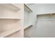 A bright and spacious closet with multiple shelves and wooden bars at 6830 W Desert Ln, Laveen, AZ 85339