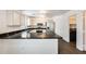 Modern kitchen with marble countertops, stainless steel appliances, and white cabinetry at 6830 W Desert Ln, Laveen, AZ 85339