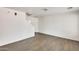 Bright, open-concept living room with wood-look tile flooring and neutral paint at 6830 W Desert Ln, Laveen, AZ 85339