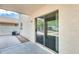 Covered patio area featuring neutral colors and a sliding glass door to the interior at 6830 W Desert Ln, Laveen, AZ 85339