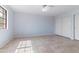 Bright bedroom featuring neutral tile flooring, ceiling fan, a window, and closet with sliding doors at 7800 E Lincoln Dr # 2092, Scottsdale, AZ 85250
