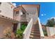 Inviting condo entrance featuring a secure screen door and a stairway leading to the upper-level unit at 7800 E Lincoln Dr # 2092, Scottsdale, AZ 85250