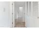 Hallway with neutral tile floors and white walls featuring a storage closet at 7800 E Lincoln Dr # 2092, Scottsdale, AZ 85250