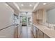 Bright, functional kitchen with white appliances, a sink, and an open layout leading to the outdoor balcony at 7800 E Lincoln Dr # 2092, Scottsdale, AZ 85250