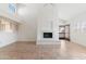 Cozy living room featuring tile floors, a fireplace, and access to the outdoor balcony through a glass door at 7800 E Lincoln Dr # 2092, Scottsdale, AZ 85250