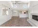 Spacious living room with tile flooring, a fireplace, and a view to a pass-through kitchen at 7800 E Lincoln Dr # 2092, Scottsdale, AZ 85250