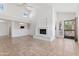 Bright living room featuring a fireplace, tile floors, and an open layout connecting to the kitchen at 7800 E Lincoln Dr # 2092, Scottsdale, AZ 85250