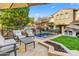 Inviting backyard featuring a pool, fire pit, seating area, and lush landscaping at 9087 E Mountain Spring Rd, Scottsdale, AZ 85255