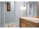 Bathroom featuring a vanity with granite countertop, decorative mirror, and stylish fixtures at 9087 E Mountain Spring Rd, Scottsdale, AZ 85255