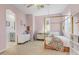 Charming pink bedroom featuring a four-poster bed and an ensuite bathroom at 9087 E Mountain Spring Rd, Scottsdale, AZ 85255