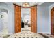 Bedroom view featuring wooden sliding doors leading into the room, enhancing its cozy ambiance at 9087 E Mountain Spring Rd, Scottsdale, AZ 85255