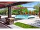 Community pool area with comfortable seating and shade structures for relaxation at 9087 E Mountain Spring Rd, Scottsdale, AZ 85255
