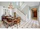 Inviting dining room boasts a wooden table and chairs set beneath an elegant chandelier, with staircase nearby at 9087 E Mountain Spring Rd, Scottsdale, AZ 85255