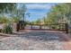 Gated entrance to the property featuring stone pillars and a decorative wooden gate at 9087 E Mountain Spring Rd, Scottsdale, AZ 85255