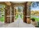 Stone archway frames a view of the landscaped front yard, creating a grand entrance at 9087 E Mountain Spring Rd, Scottsdale, AZ 85255