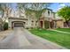 Attractive home exterior with lush green lawn, mature trees, and porte-cochere at 9087 E Mountain Spring Rd, Scottsdale, AZ 85255