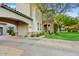Charming home exterior with a porte-cochere, stone accents, and mature landscaping at 9087 E Mountain Spring Rd, Scottsdale, AZ 85255