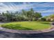 Expansive front lawn with a circular driveway and mature trees enhancing the curb appeal of the home at 9087 E Mountain Spring Rd, Scottsdale, AZ 85255