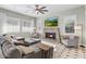 Cozy living room with a stone fireplace, plantation shutters, and neutral décor at 9087 E Mountain Spring Rd, Scottsdale, AZ 85255
