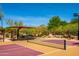 Outdoor pickleball court with a shaded seating area and beautiful desert scenery at 9087 E Mountain Spring Rd, Scottsdale, AZ 85255