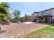 Expansive backyard featuring a pool, seating area, mature trees and desert landscaping at 9662 W Sunnyslope Ln, Peoria, AZ 85345