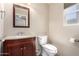 Bathroom with granite vanity top, framed mirror and toilet at 9662 W Sunnyslope Ln, Peoria, AZ 85345