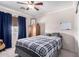 Cozy bedroom with a ceiling fan, window, carpet and comfortable bed at 9662 W Sunnyslope Ln, Peoria, AZ 85345
