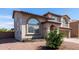 Two-story home with desert landscaping, arched windows, and neutral-toned stucco siding at 9662 W Sunnyslope Ln, Peoria, AZ 85345