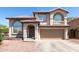 Two-story home with desert landscaping, arched windows, and a two car garage at 9662 W Sunnyslope Ln, Peoria, AZ 85345