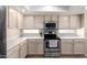 Kitchen featuring stainless steel appliances, tile floors, and ample counter space at 9662 W Sunnyslope Ln, Peoria, AZ 85345