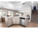 Open concept kitchen with tile floors, island sink, and stainless steel dishwasher at 9662 W Sunnyslope Ln, Peoria, AZ 85345