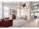 Open floor plan with high ceilings, carpet, sofa, and staircase to the second floor at 9662 W Sunnyslope Ln, Peoria, AZ 85345
