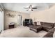 Cozy living room with ceiling fan, carpet, comfortable seating and desk at 9662 W Sunnyslope Ln, Peoria, AZ 85345