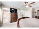 Main bedroom featuring carpet floors and a large dresser with a TV at 9662 W Sunnyslope Ln, Peoria, AZ 85345