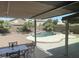 Relaxing backyard with desert landscaping, a pool with a rock waterfall, and a covered patio with dining set at 9662 W Sunnyslope Ln, Peoria, AZ 85345