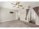 Spacious bedroom featuring a ceiling fan, neutral tones, and access to an ensuite bathroom at 1016 W Juanita Ave, Gilbert, AZ 85233