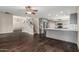 Open-concept living room featuring a staircase, hardwood floors, and modern kitchen at 1016 W Juanita Ave, Gilbert, AZ 85233